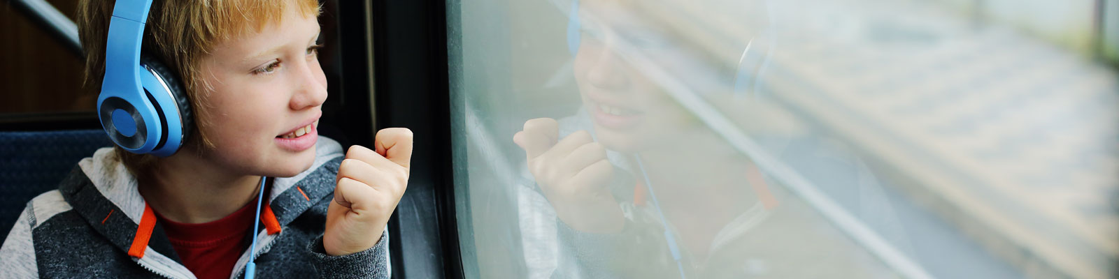 Autism - ASD - Autistic Child with headphones on train - Communicating Above Barriers